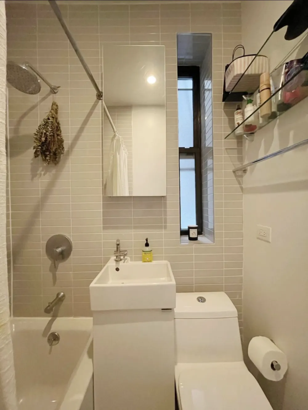 Modern compact bathroom with organized shelves.
