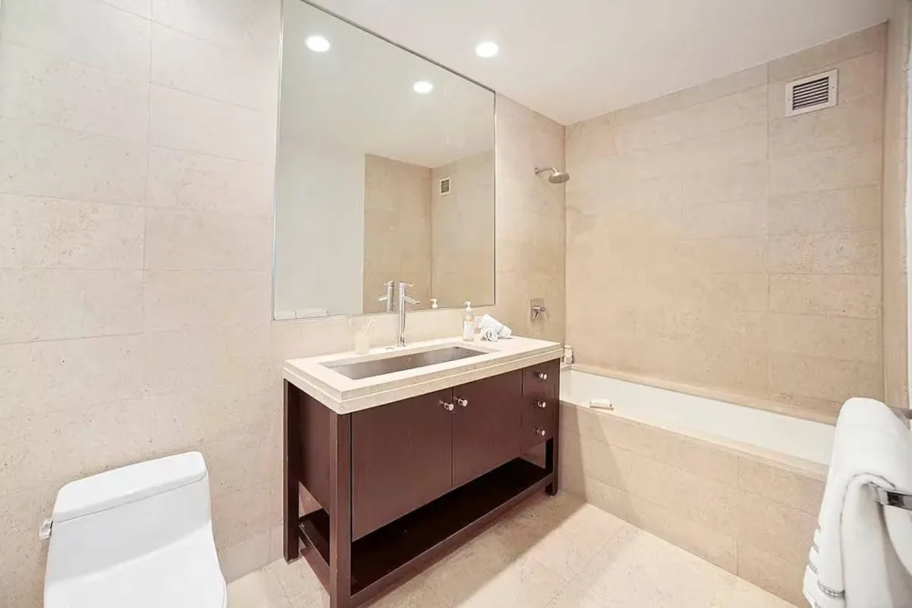 Modern bathroom with large mirror.