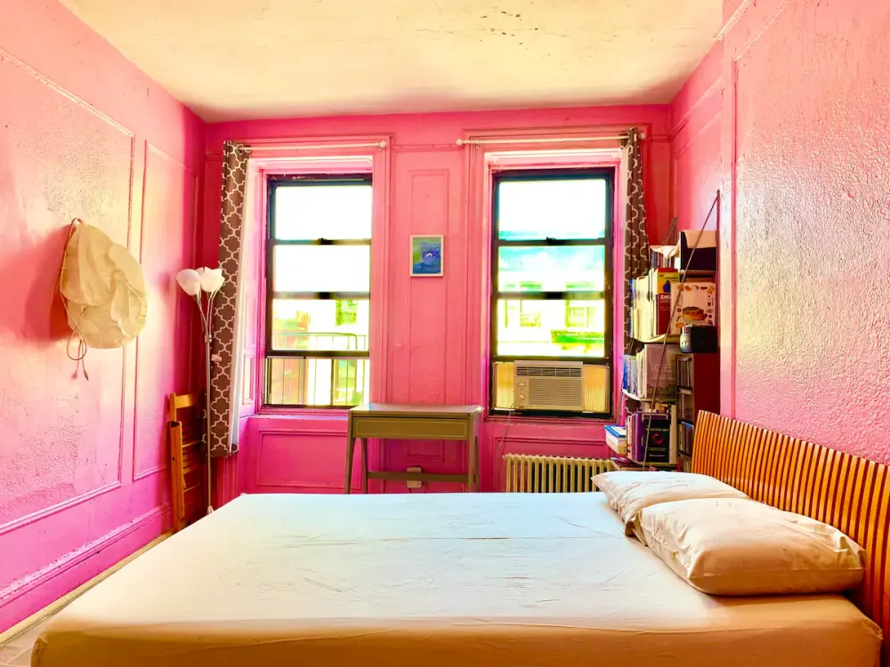 Bright pink bedroom with windows.