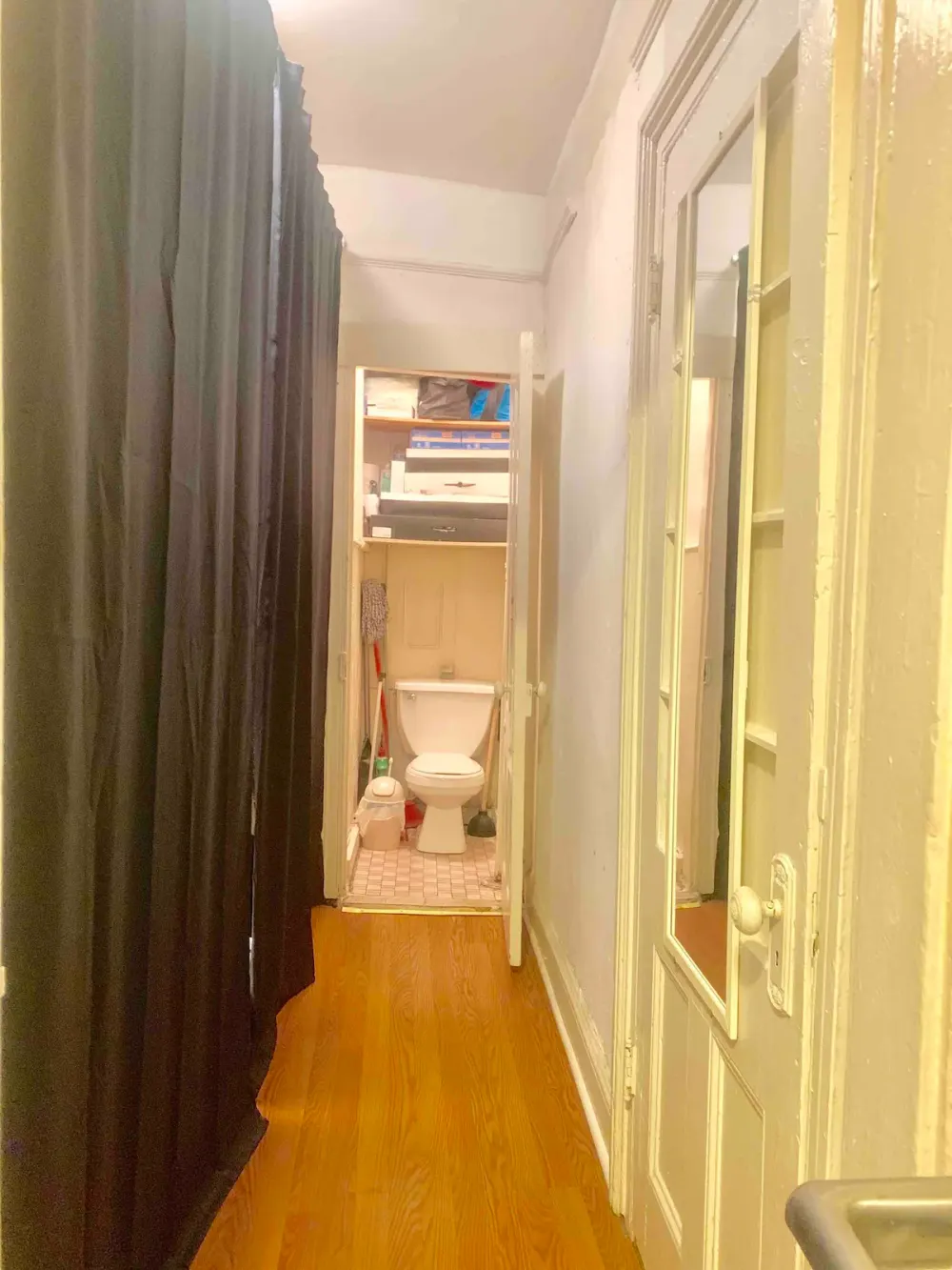 Narrow hallway leading to restroom.