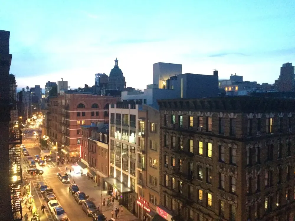 Evening cityscape with lit streets.