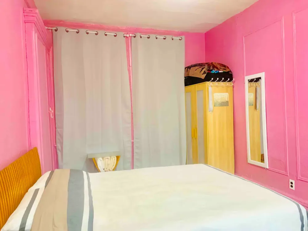 Bright pink room with bed