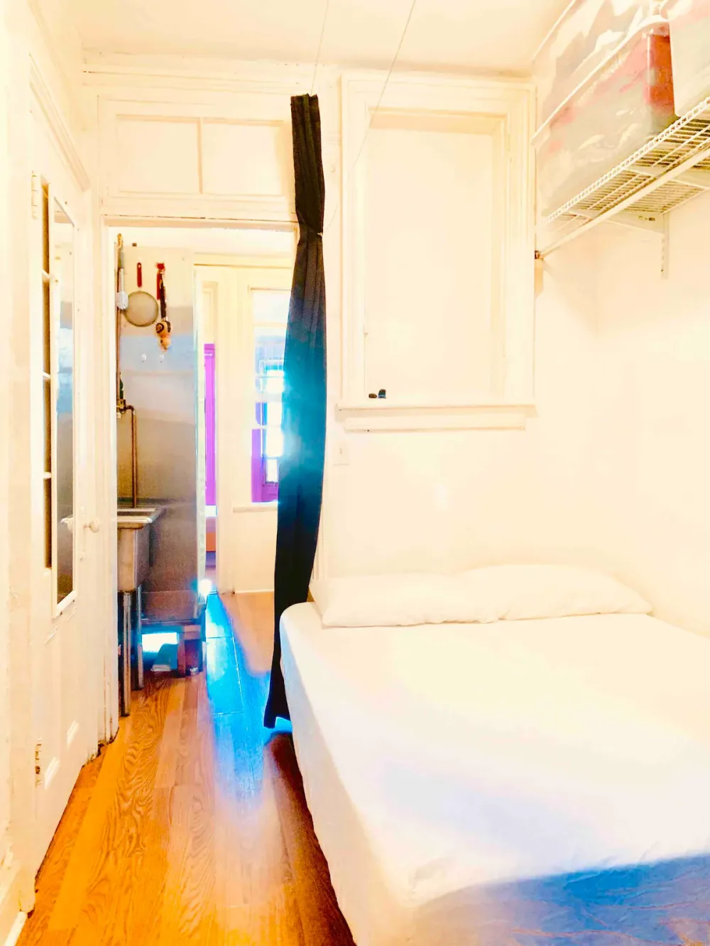 Cozy bedroom with wooden flooring.