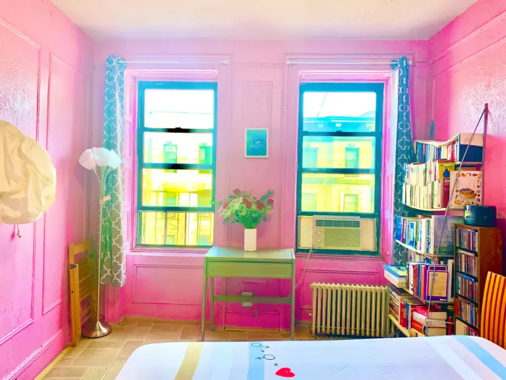Bright pink room with bookshelves.