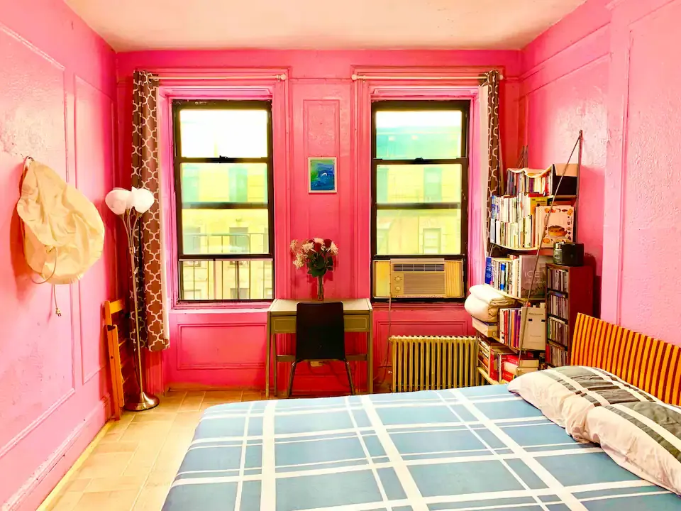 Vibrant bedroom with pink walls.