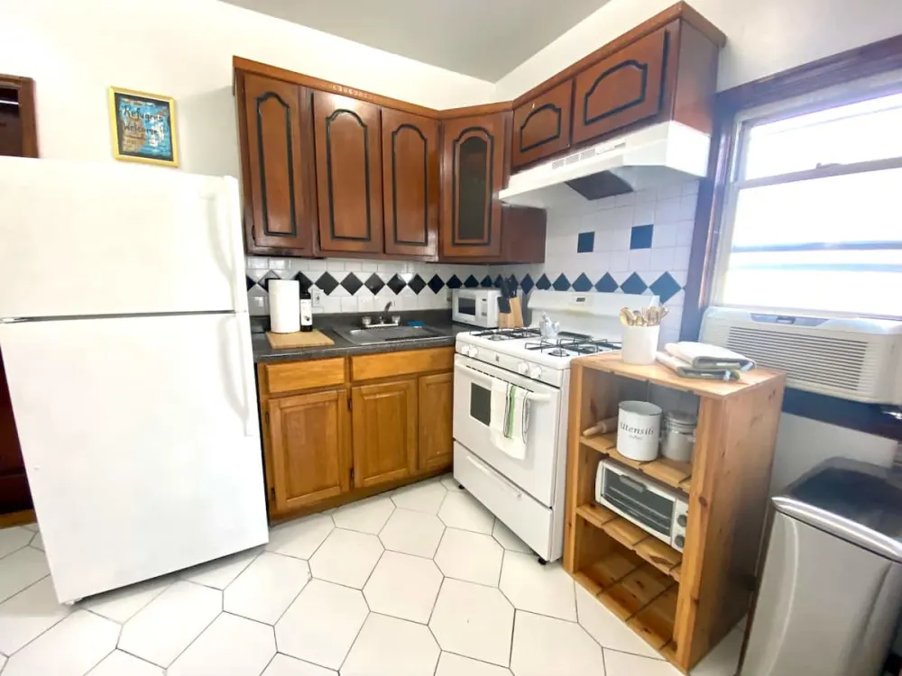 Compact kitchen with wooden cabinets.