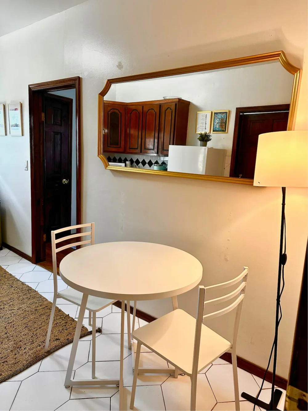 Cozy dining nook with mirror.