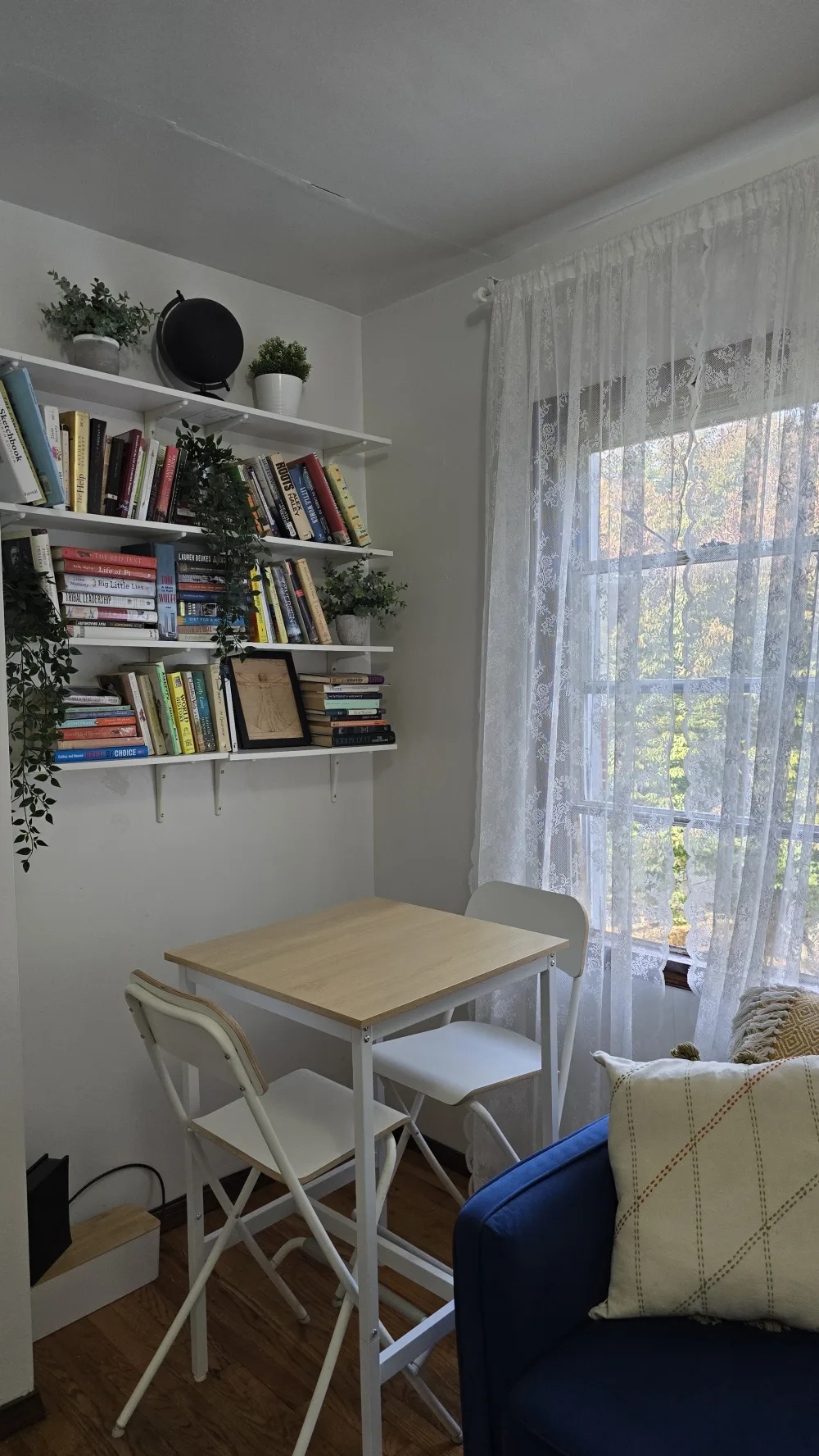 Cozy room with bookshelves and table.