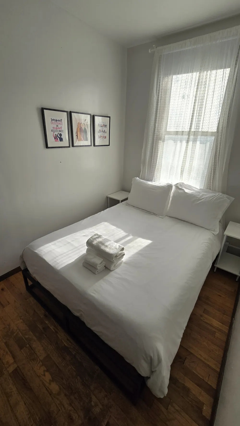 Bright, minimalist bedroom with artwork.