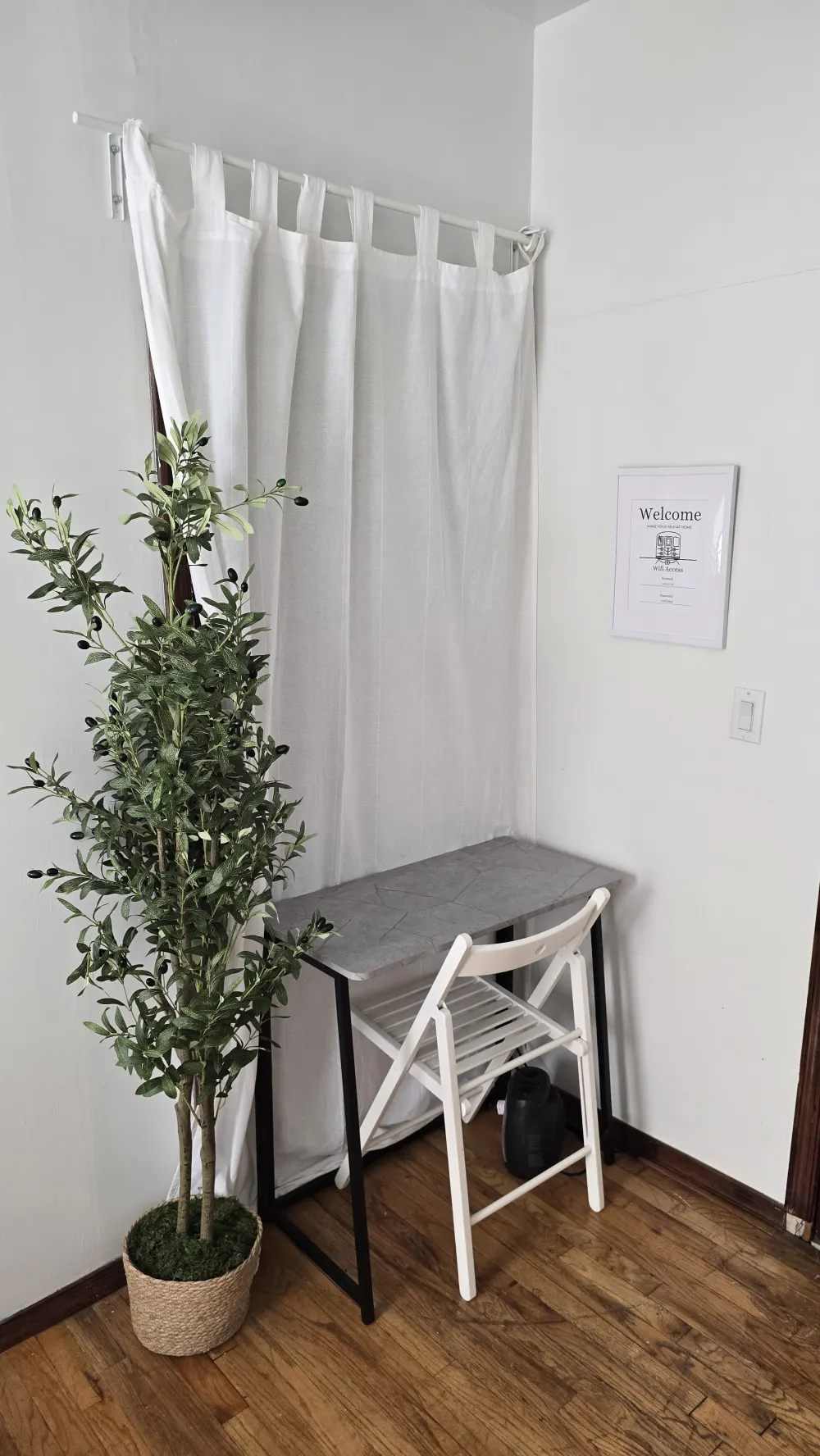 Simple desk, chair, and plant.