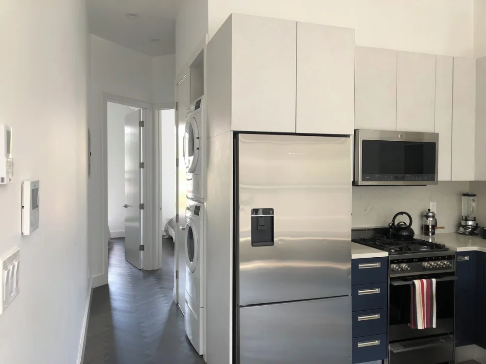 Modern kitchen with stainless steel appliances.