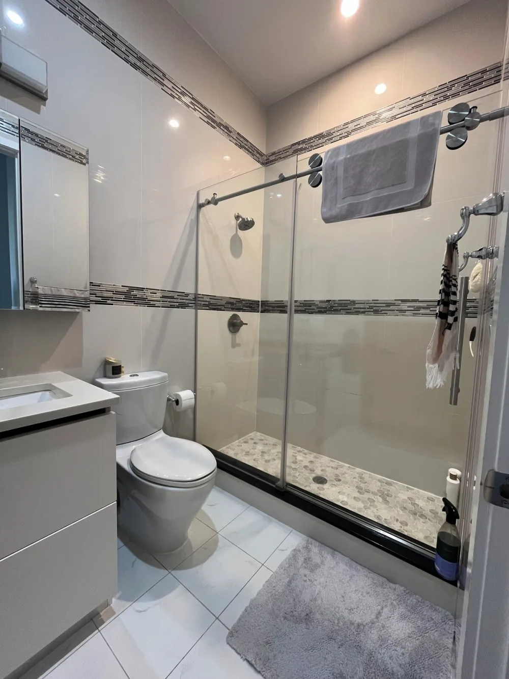 Modern bathroom with glass shower enclosure.