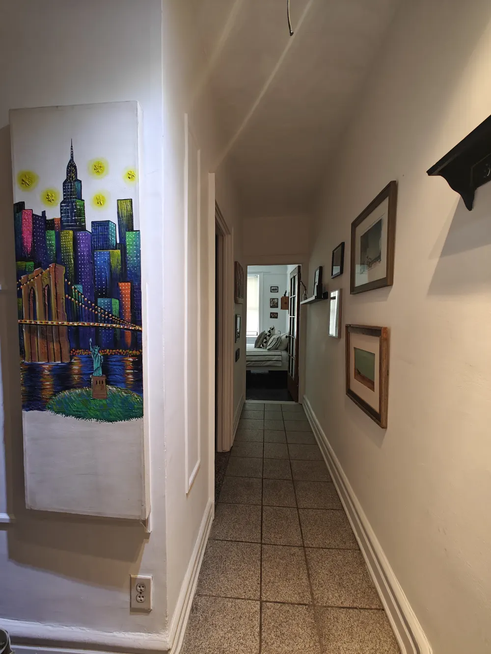 Narrow hallway with NYC artwork.