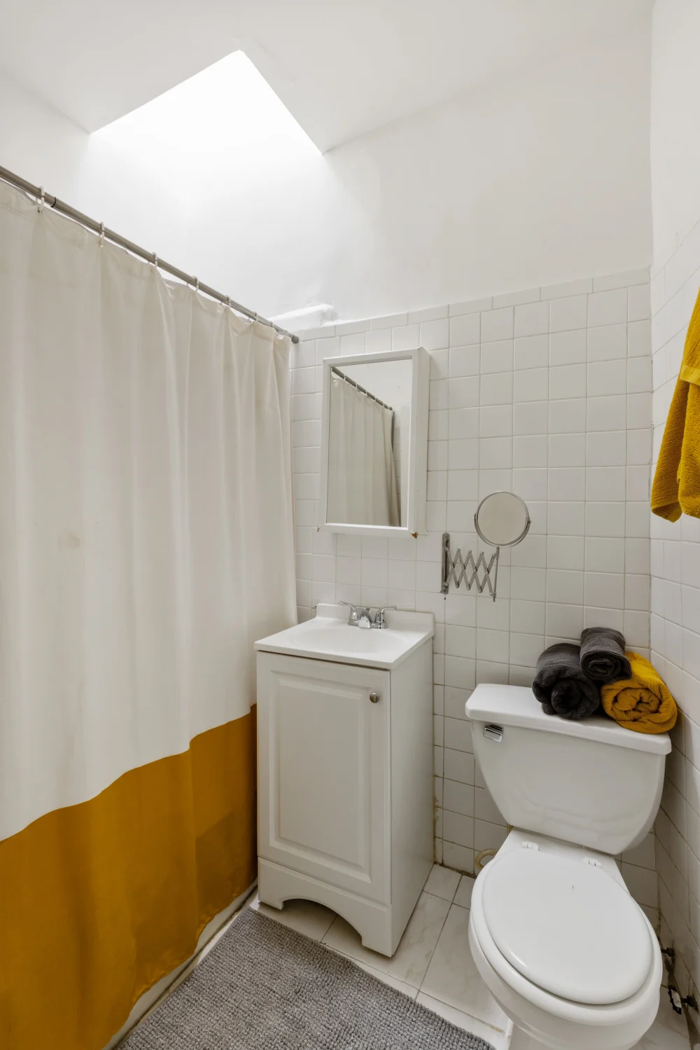 Cozy, modern bathroom with skylight.