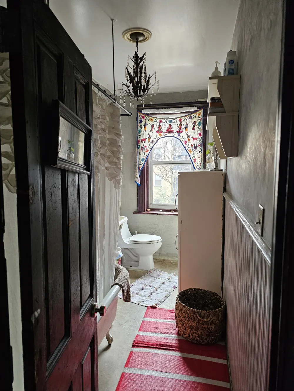 Eclectic bathroom with colorful accents.