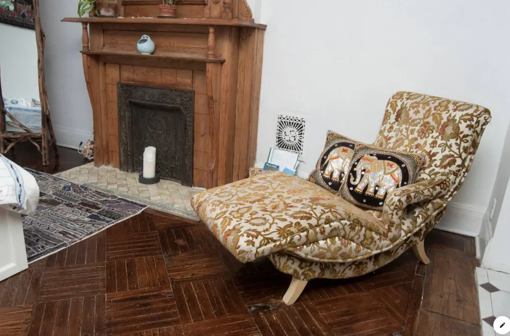 Vintage lounge chair by fireplace.