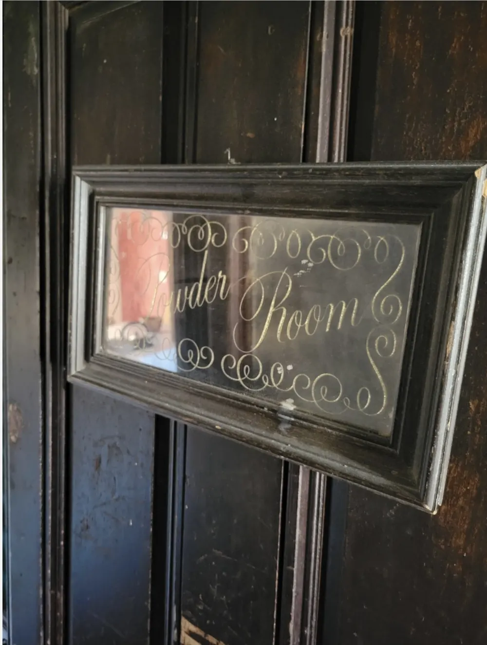 Elegant powder room sign displayed.