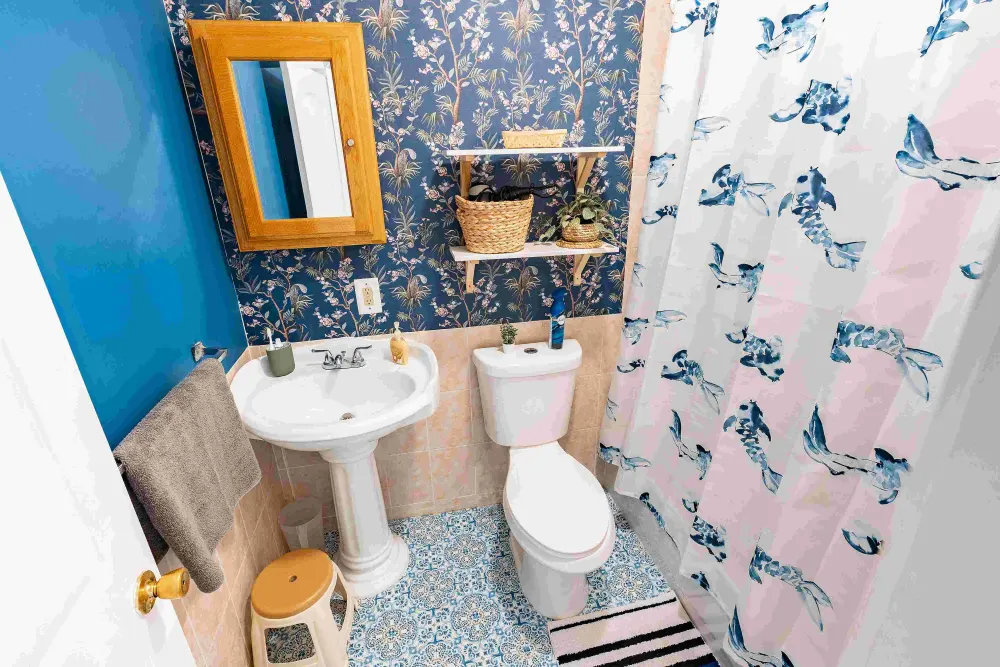 Bright bathroom with blue wallpaper.