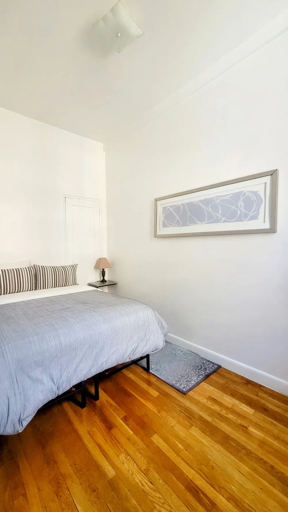 Bright minimalist bedroom, hardwood floor.