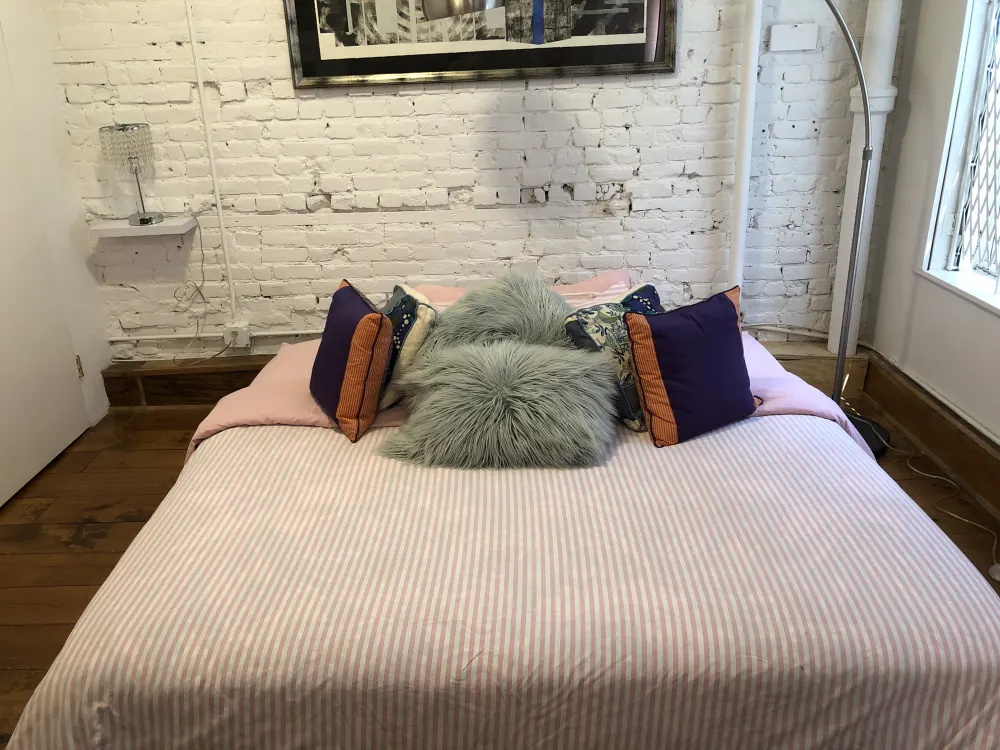 Cozy bedroom with colorful pillows.