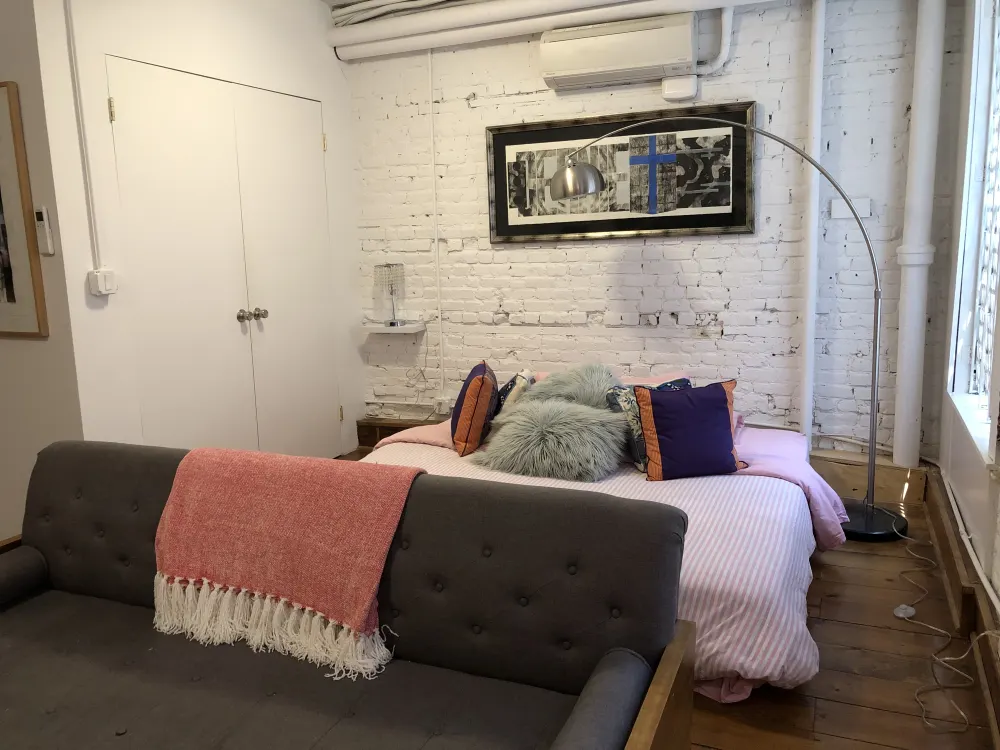 Chic, cozy studio bed area