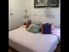 Cozy bedroom with decorative pillows.