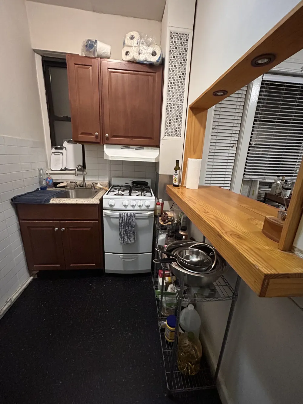 Compact kitchen with wooden cabinets.