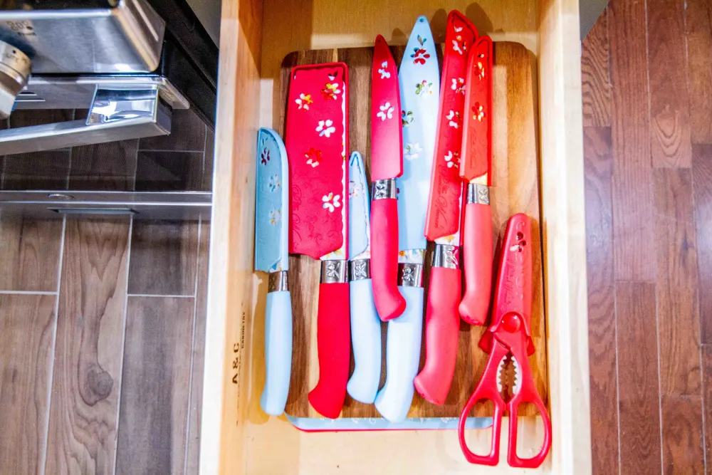 Colorful knives and scissors drawer.