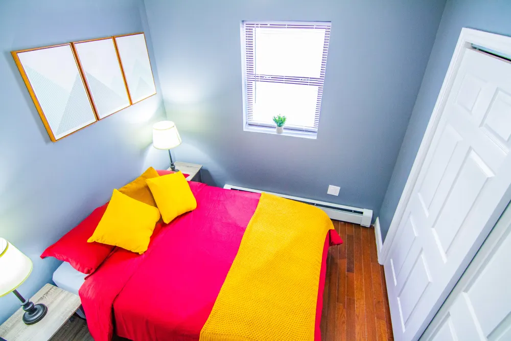 Colorful cozy bedroom with window.