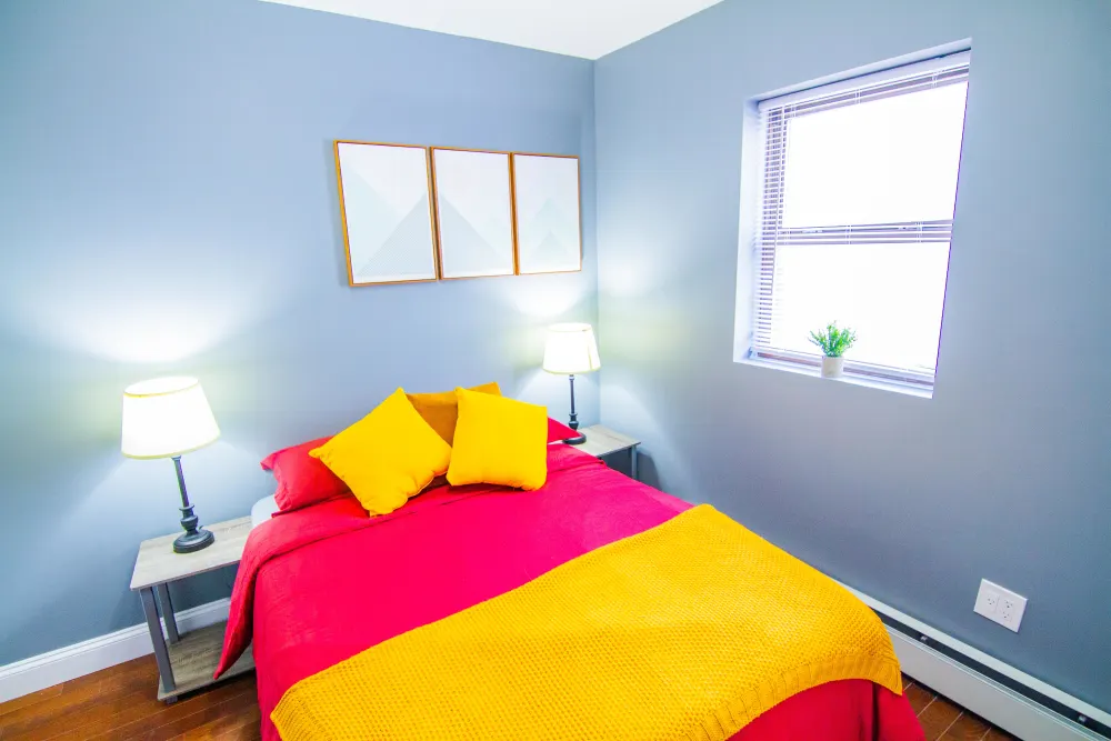 Bright bedroom with colorful bedding.