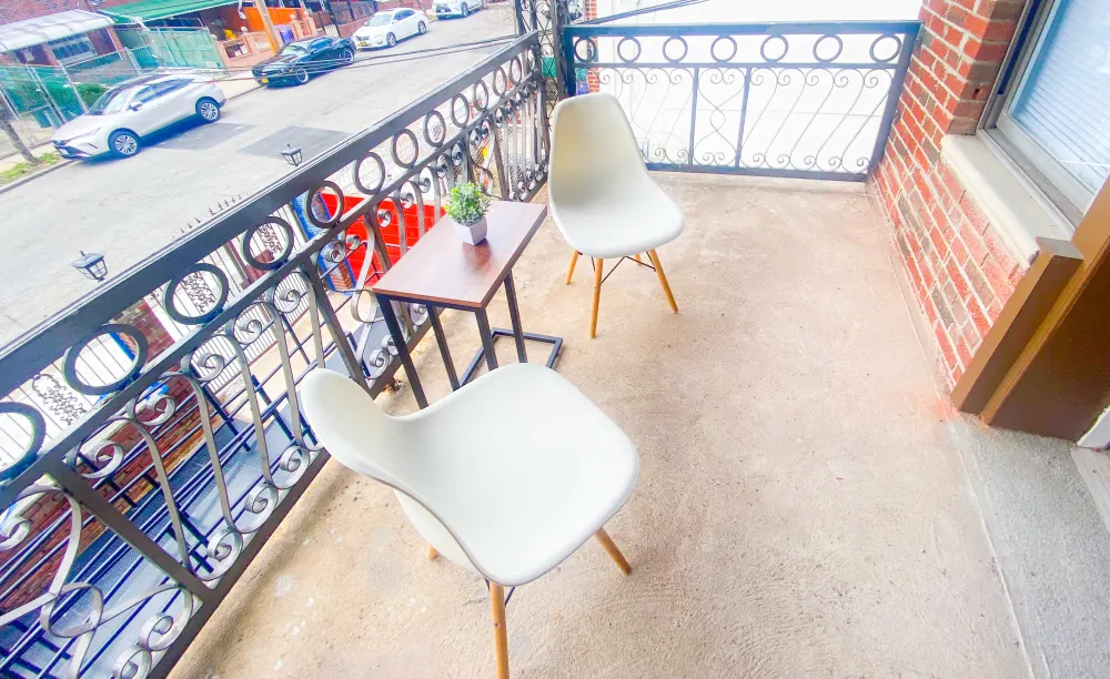 Cozy balcony with seating area.