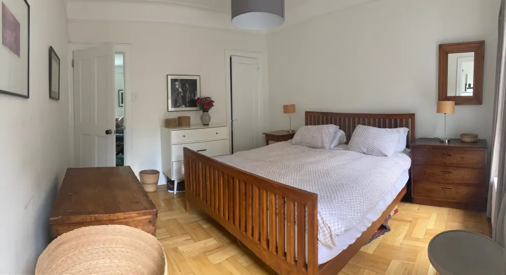 Cozy bedroom with wooden furniture.