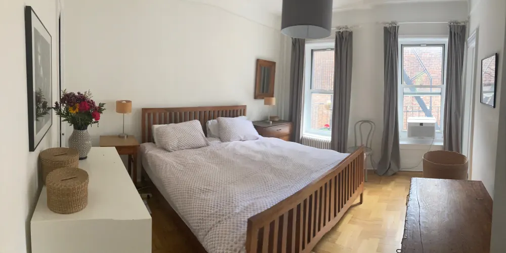 Cozy, minimalist bedroom with flowers.