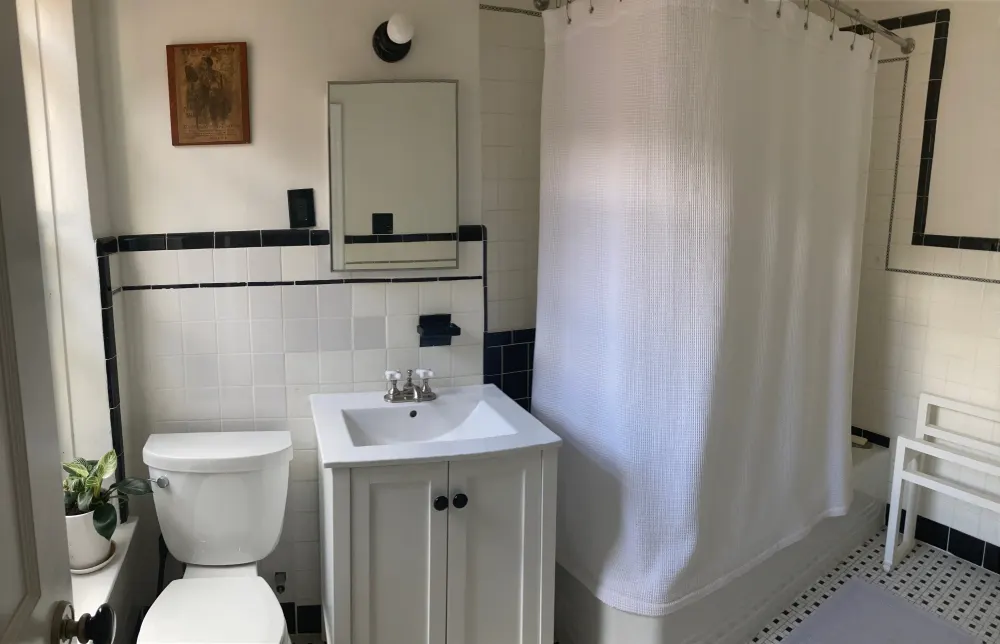 Classic white-tiled hotel bathroom.