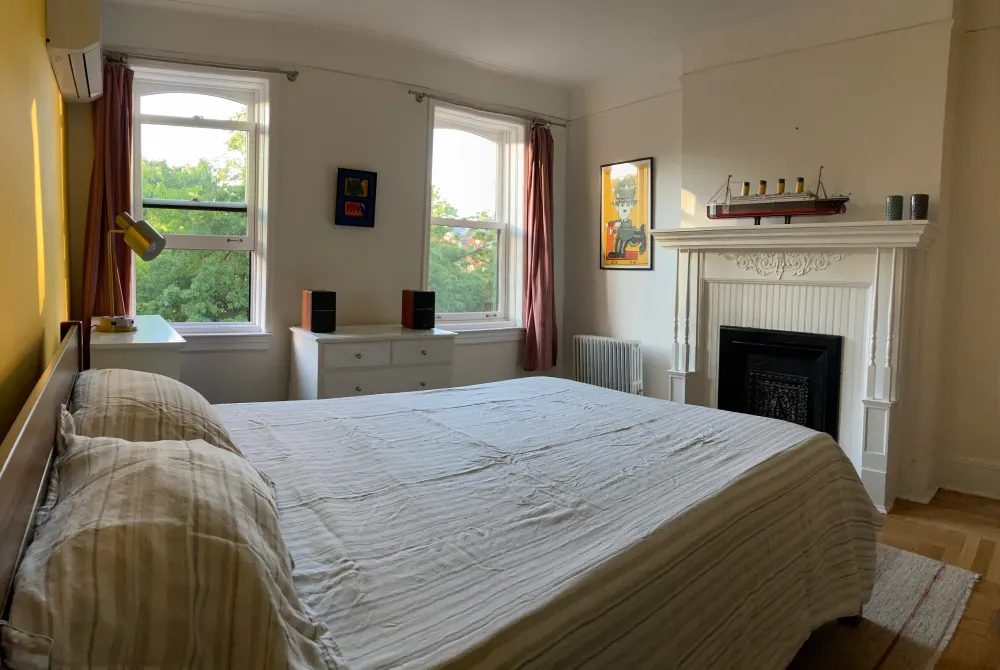 Cozy bedroom with large windows.
