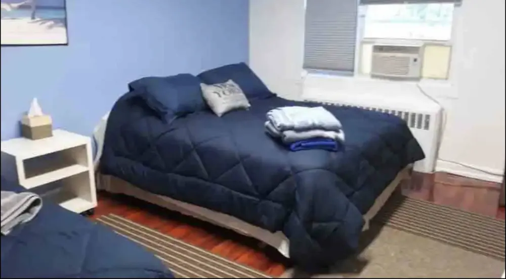 Cozy bedroom with blue bedding.