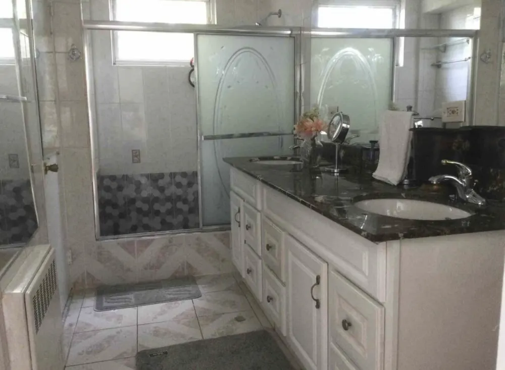 Bathroom with large mirrored vanity.