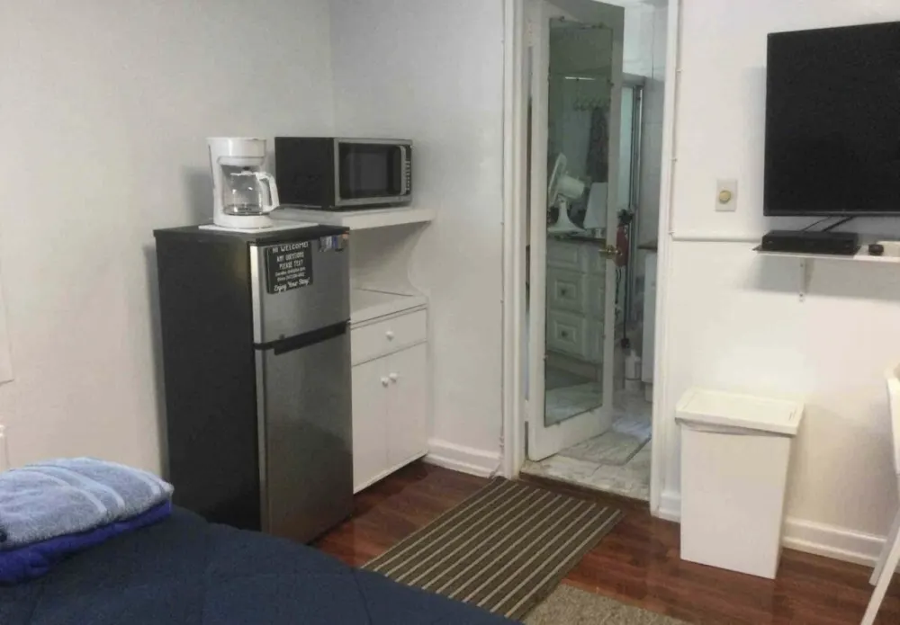 Compact room with kitchenette amenities.