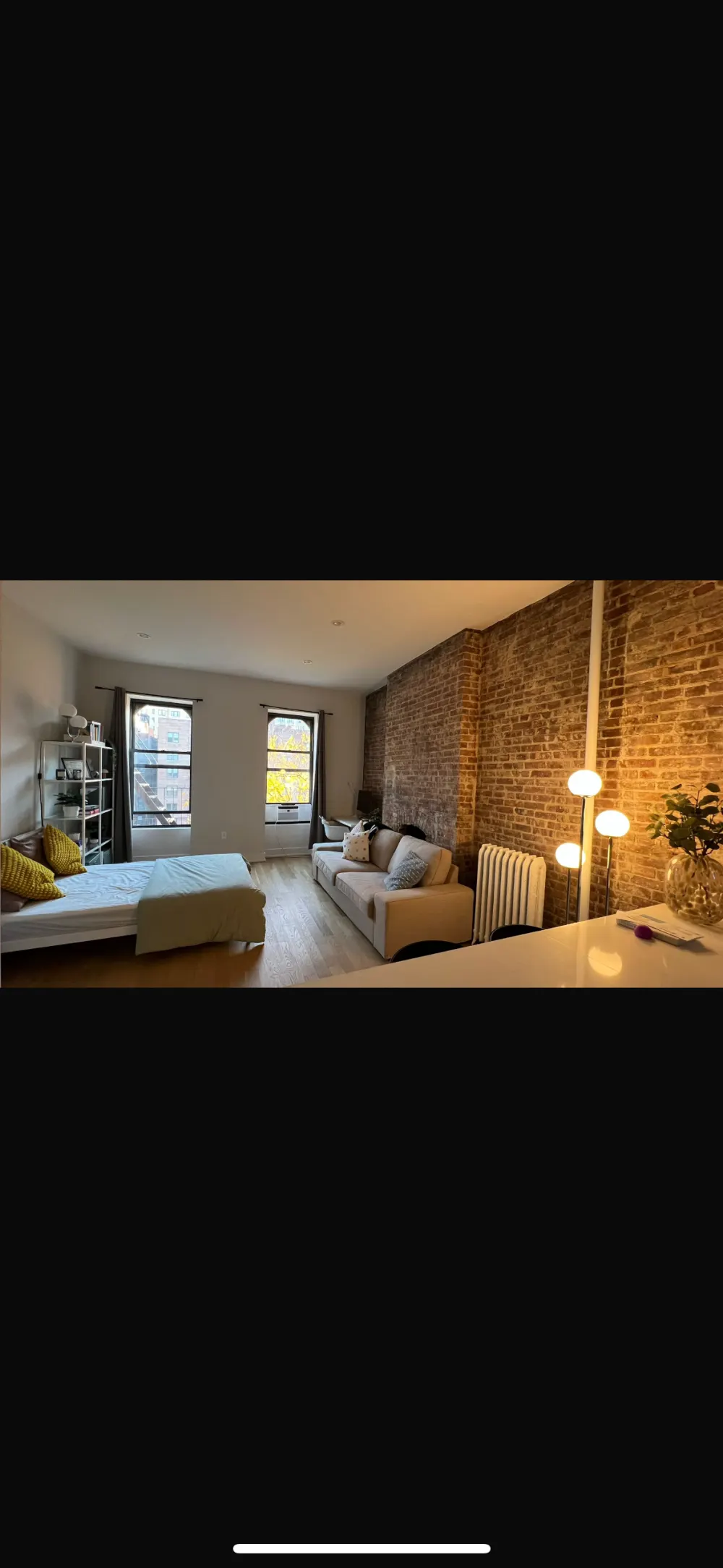 Cozy studio with brick walls.