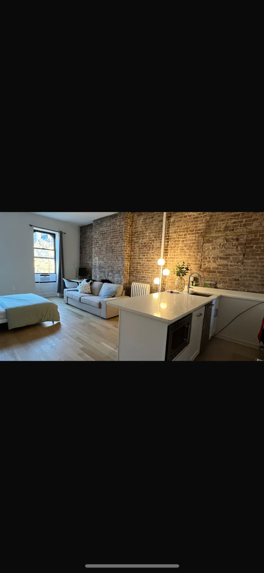 Cozy studio with exposed brick.