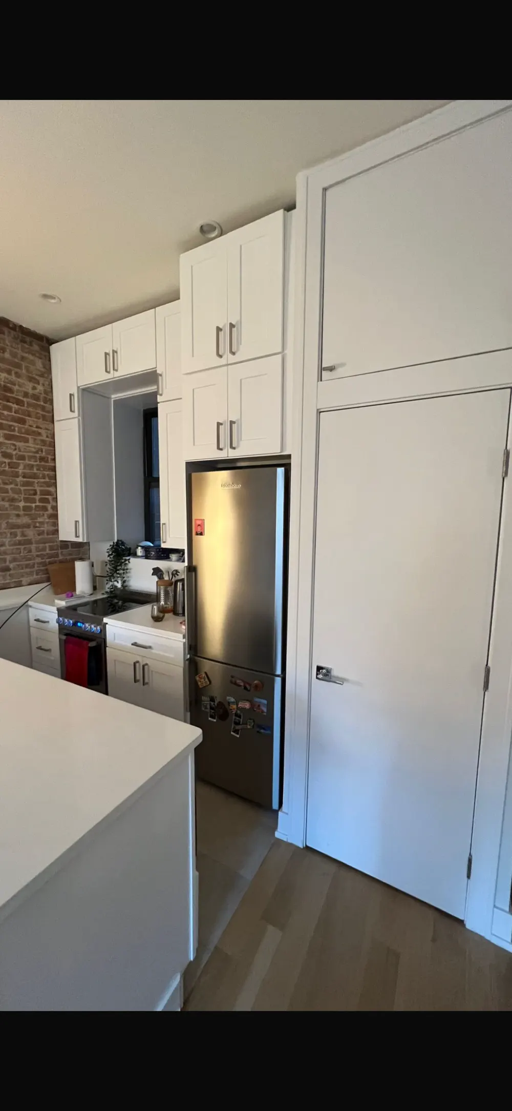 Modern kitchen with stainless appliances.