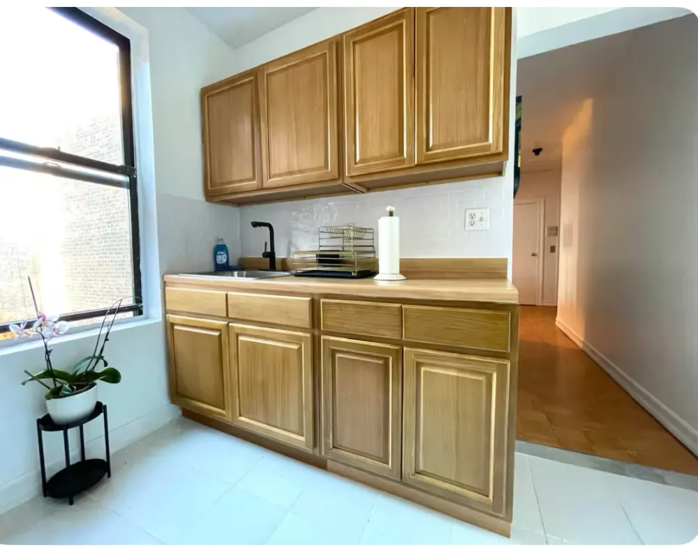 Bright kitchen with wooden cabinets.
