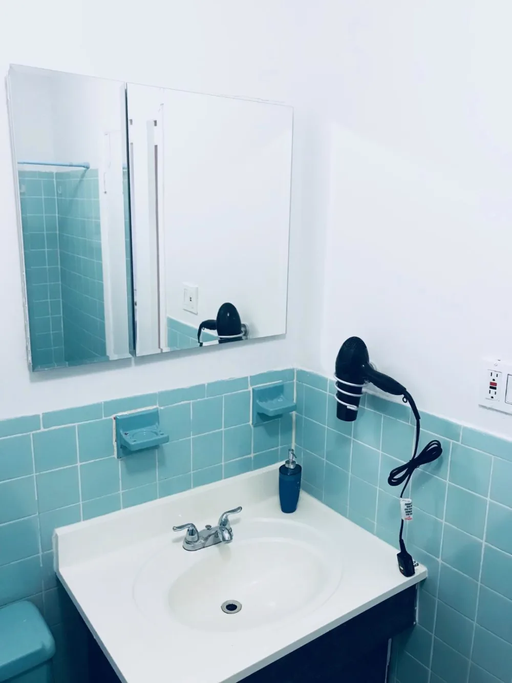 Bathroom with blue tiled walls.
