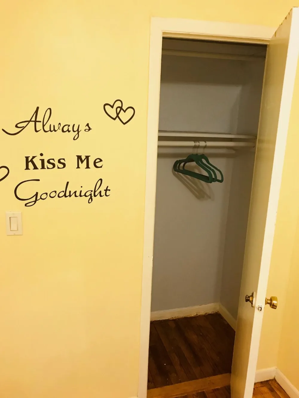 Wall quote beside empty closet.