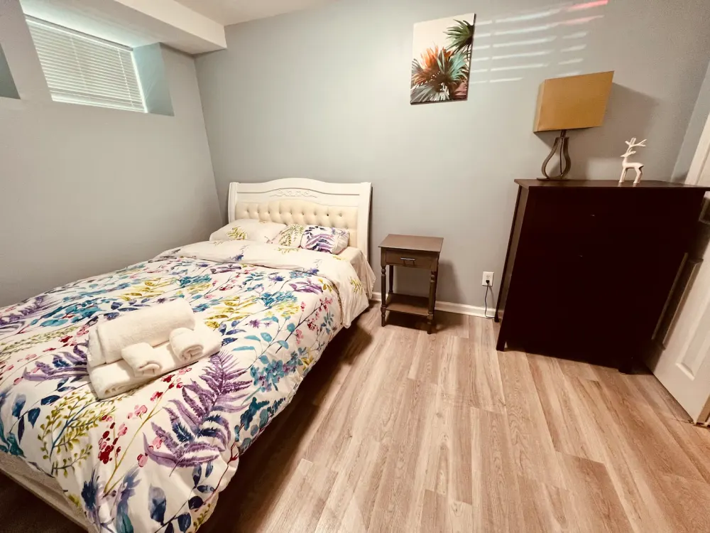 Cozy bedroom with floral bedding.