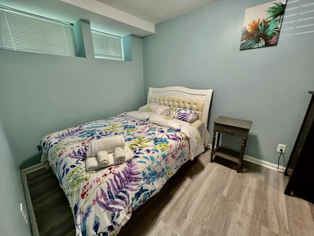 Bright cozy bedroom with floral bedding.