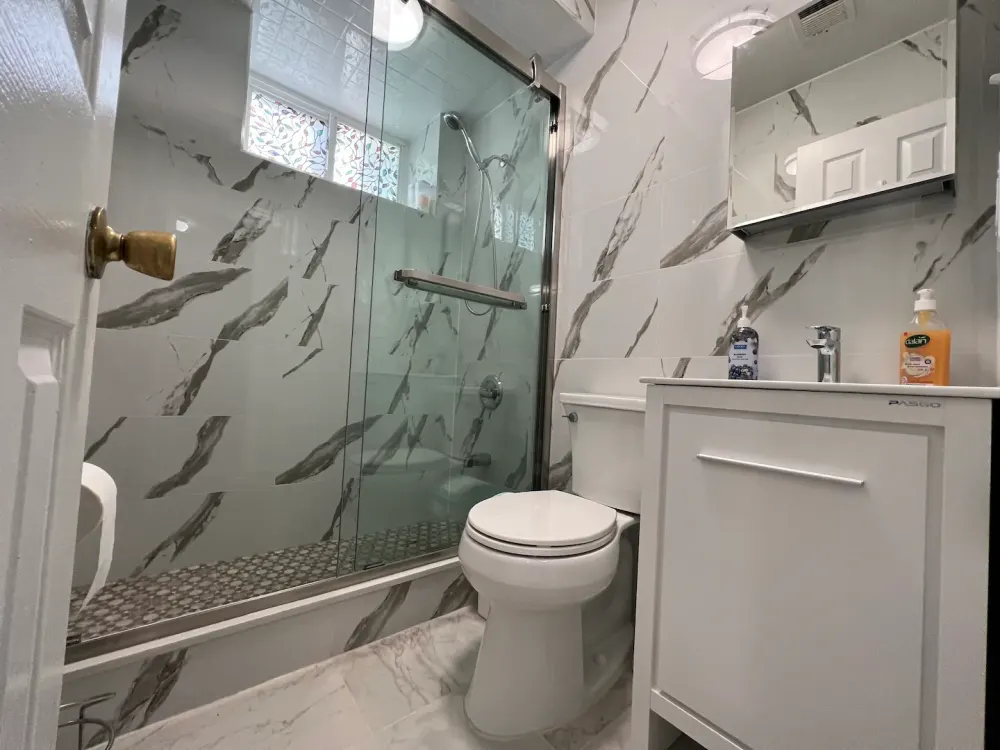 Modern bathroom with glass shower door.