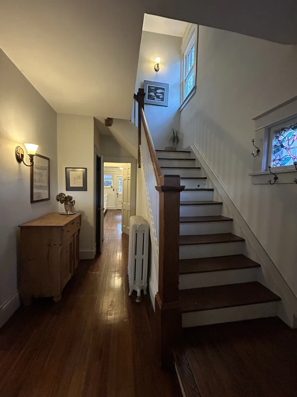 Staircase in cozy, well-lit hallway.
