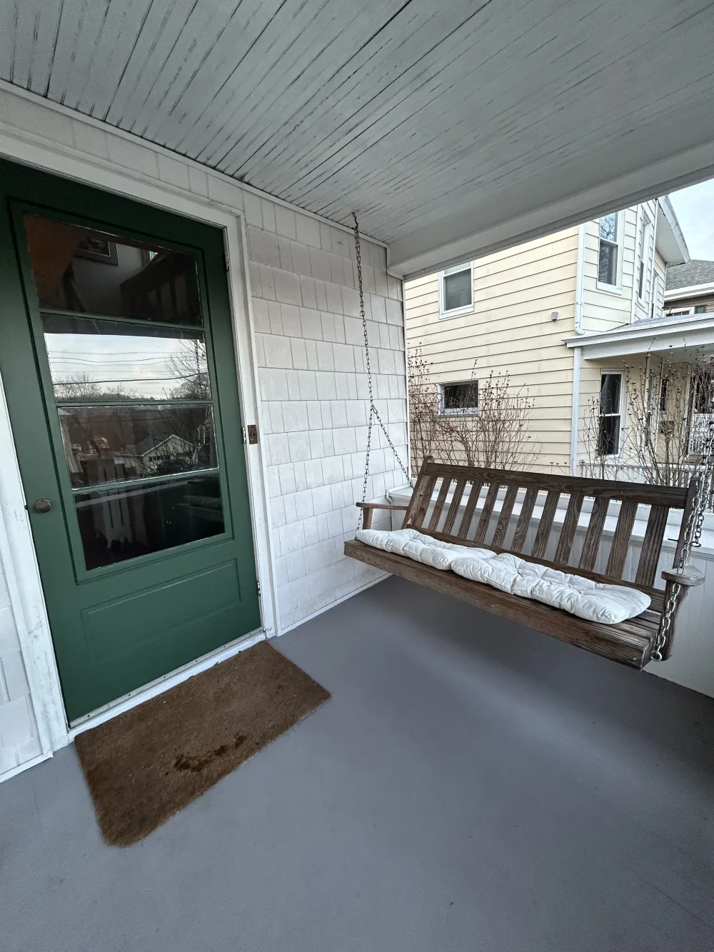 Porch with swing and door.