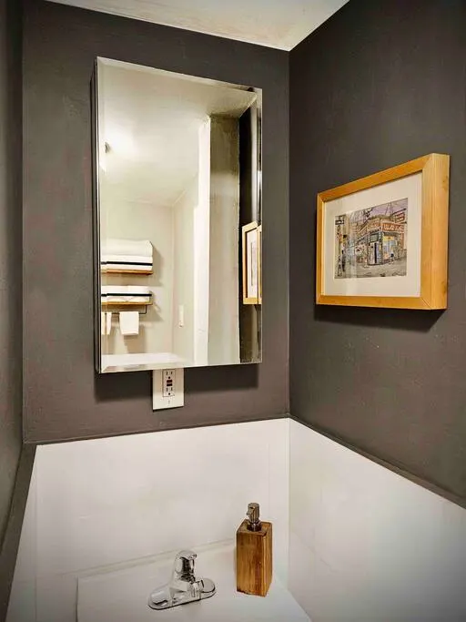 Modern bathroom with dark walls.